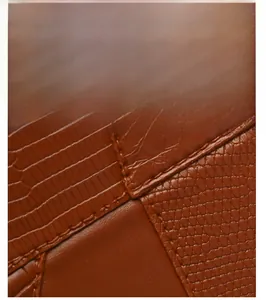 Detail of brown lizard embossed synthetic leather with premium stitching on tote bag