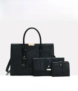Three-piece black embossed tote bag set with crocodile texture and golden hardware