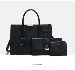 Three-piece black embossed leather tote bag set including handbag and wallet with gold accents