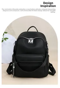 Detail view of black lychee grain PU leather texture and silver metal zippers on backpack
