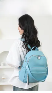 Close-up of sky blue lychee pattern backpack showing adjustable straps and silver hardware