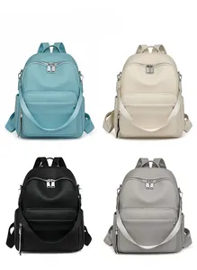 Collection of minimalist women's backpacks in blue, off-white, black, and grey colors