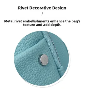 Detail of light blue lychee pattern leather backpack with silver metal rivet accents