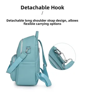 Detail of light blue faux leather backpack with silver metal hooks and side pocket