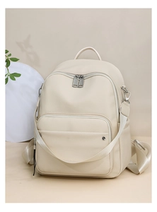 Close-up of off-white lychee leather backpack with woven straps and front zipper pocket