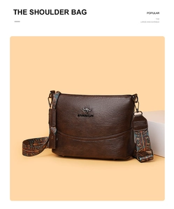 Detail der dunkelbraunen Leder-Eimertasche mit buntem Ethno-Gurt und Metall-Logo