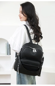 Side view of black lychee grain backpack showing multi-pocket structure and large capacity