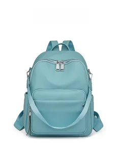 Front detail of sky blue lychee grain leather backpack with silver zippers and side pockets