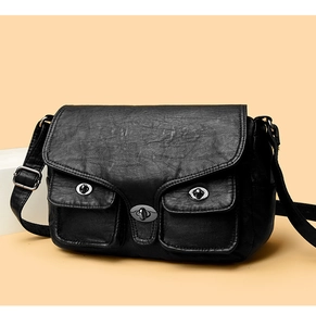 Detail of vintage black washed leather bag with three silver metallic twist-lock buckles