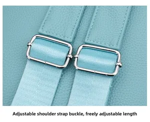 Detail of adjustable blue nylon straps with silver metal buckles on a stylish backpack