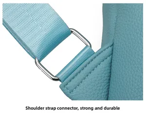 Detail of lychee pattern leather backpack strap connection with silver metal ring