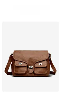 Detailed view of brown vintage baguette bag with metallic buckles and wrinkled texture