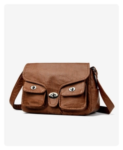 Close-up of vintage brown messenger bag with silver metal buckles and multiple pockets
