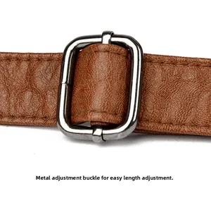 Close-up of adjustable silver metal buckle and brown lychee grain leather strap detail