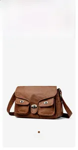 Detailed shot of caramel PU leather bag featuring retro textures and twin turn-lock pockets