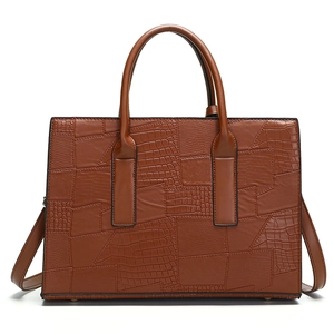 Brown crocodile embossed tote bag with dual handles and adjustable shoulder strap