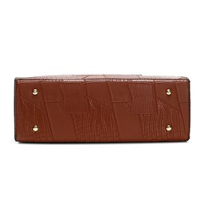 Bottom view of brown embossed leather tote bag with protective golden metal feet