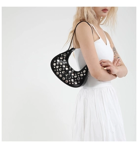 Detail view of the black hobo bag featuring silver rivets on high-quality leather material