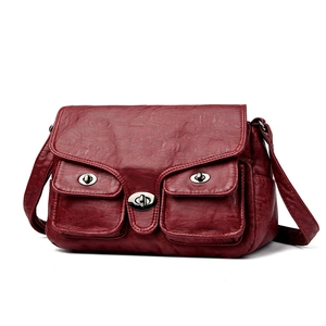 Retro dark red oil-wax leather shoulder bag with metallic turn-lock buckles in 45-degree view