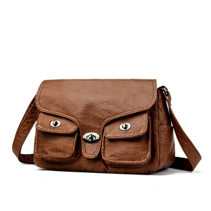 Brown vintage faux leather baguette bag with metal turn-lock pockets and adjustable strap
