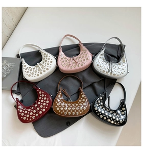 Group display of chic crescent hobo bags in six colors with metallic stud details