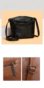 Detail of multi-layer bucket bag showing litchi texture and metal zipper pockets