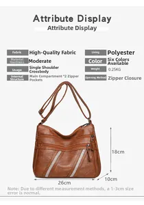 Detailed view of large brown crossbody bag with dual zip pockets and rhinestone accents