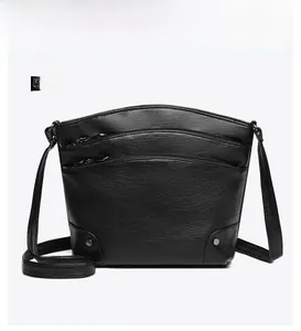 Front view of black vintage bucket bag featuring three layers of zipper compartments