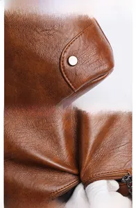 Detail view of retro caramel brown leather texture and metal buckle on bucket bag
