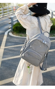 Vue extérieure d'un sac à dos léger en nylon gris imperméable avec plusieurs poches