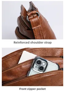 Detail of vintage brown bucket bag showing reinforced strap stitching and front zipper pocket