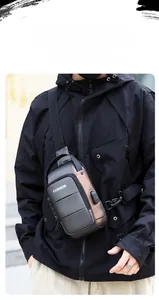 Detail view of men's hard shell chest bag with geometric design and USB charging port