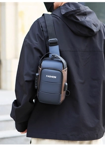 Detail of blue men's chest bag with anti-theft combination lock and USB charging port