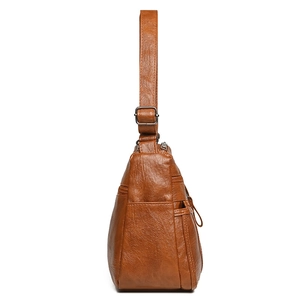 Caramel brown large capacity crossbody bag with textured leather and multiple zip pockets