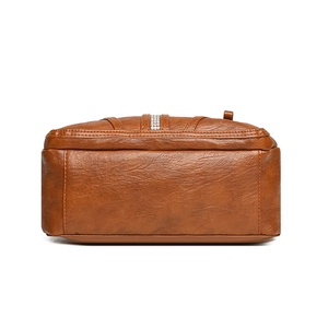 Bottom view of large brown vintage leather tote bag with elegant rhinestone accents