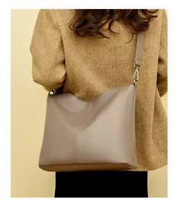 Close-up of taupe litchi texture on a large capacity women's minimalist shoulder bag