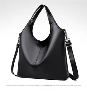 Side view of black pebble leather hobo bag with wide handle and silver metal hardware