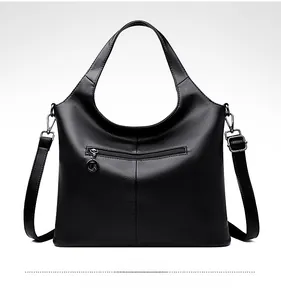 Detail view of the black pebbled leather bag back with a metal ring zipper pocket