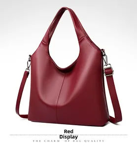 Detail of red pebbled leather tote bag with silver hardware and adjustable shoulder strap