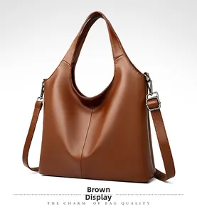 Detail of brown litchi pattern leather hobo bag with silver hardware and shoulder strap