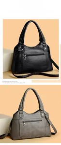 Detail of soft washed leather textures on black and grey tote bags with rivet accents