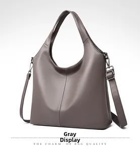 Close-up of grey litchi texture leather tote bag with sturdy handles and metal zippers