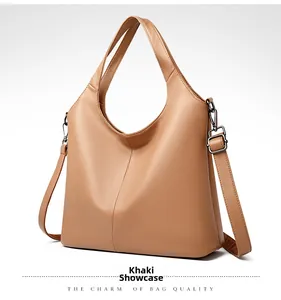 Close-up of khaki leather texture and gun-metal hardware on large shoulder bag