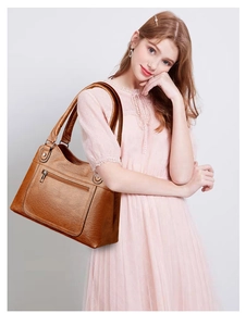 Brown faux leather tote bag detail with lychee texture and front zipper pocket