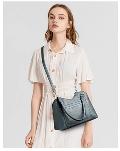 Detail view of deep blue-grey washed leather tote bag with front zipper and shoulder strap