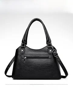 Front view of black washed leather tote bag with silver zippers and lychee texture