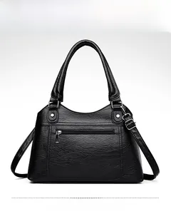 Close-up of black washed leather tote bag showing grainy texture and front zipper