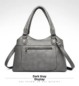 Detail view of large dark grey PU leather tote with silver zipper and soft texture