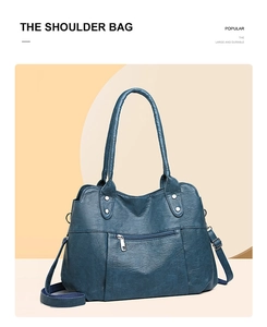 Detail of vintage large capacity navy tote bag with litchi texture and silver zipper pocket
