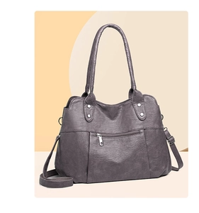 Detailed macro view of litchi texture faux leather and silver metal rivets on the bag